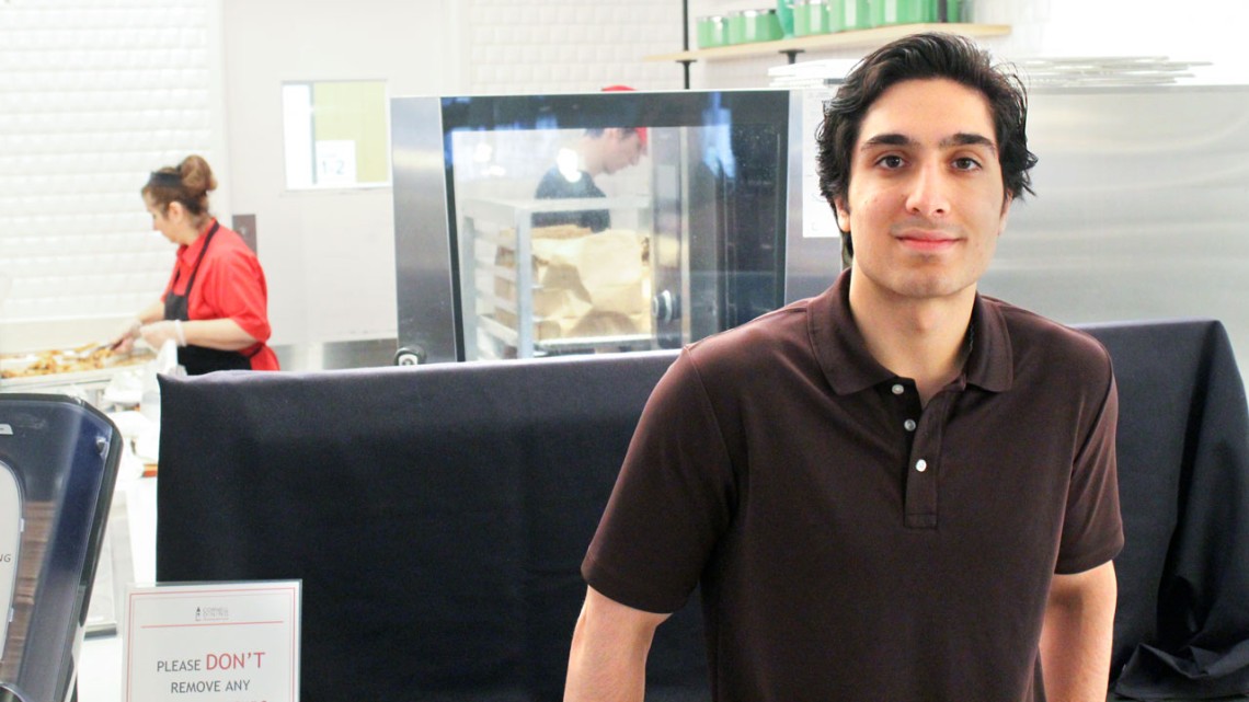 Mikhail Essa ’25 stands at the Halal Station at Morrison Dining