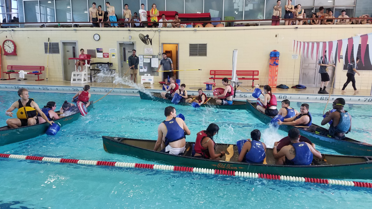Students playing canoe battleship in a pool