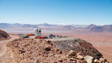 The completed Fred Young Submillimeter Telescope overlooks the vast mountains and plateaus of Chile’s Parque Astronómico Atacama.