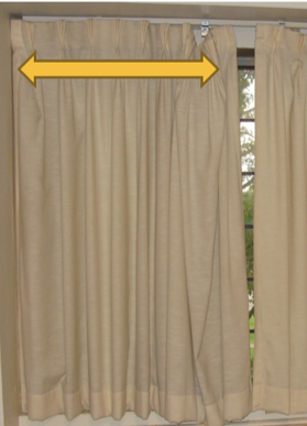 Curtains with a yellow arrow at the top pointing in both directions