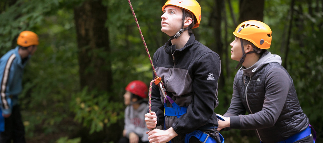 A team of belayers on the challenge course