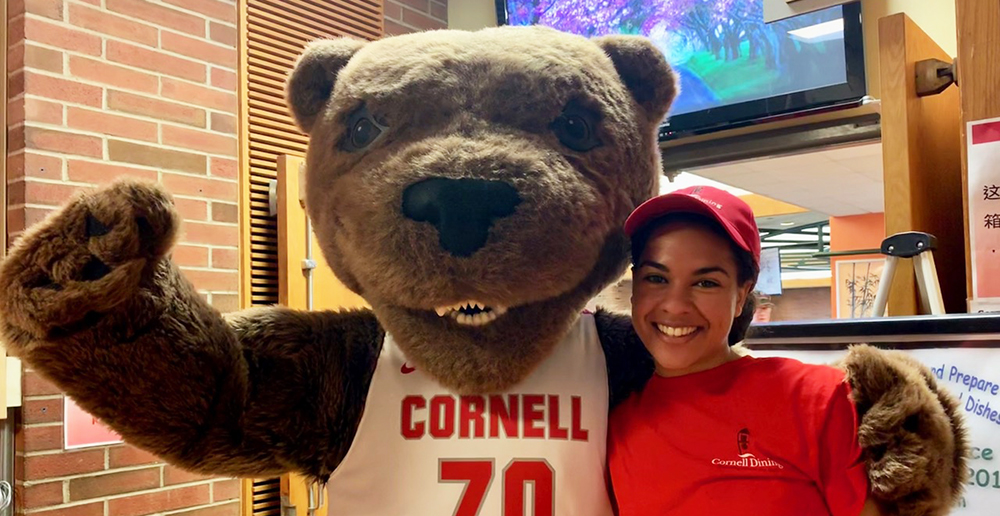 Touchdown the Bear with student Cornell Dining staff member
