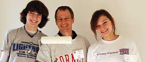 Three Cornell Cares Day volunteers smiling