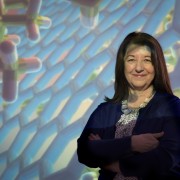 Paulette Clancy standing in front of a projected chemistry image