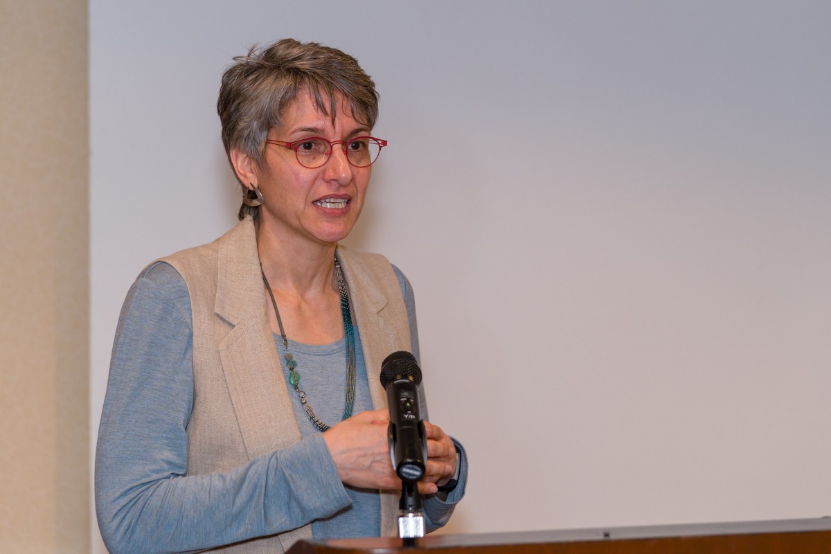 Julie Nucci presenting behind a podium