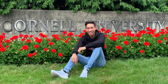 Lowe as a freshman in front of Cornell University sign