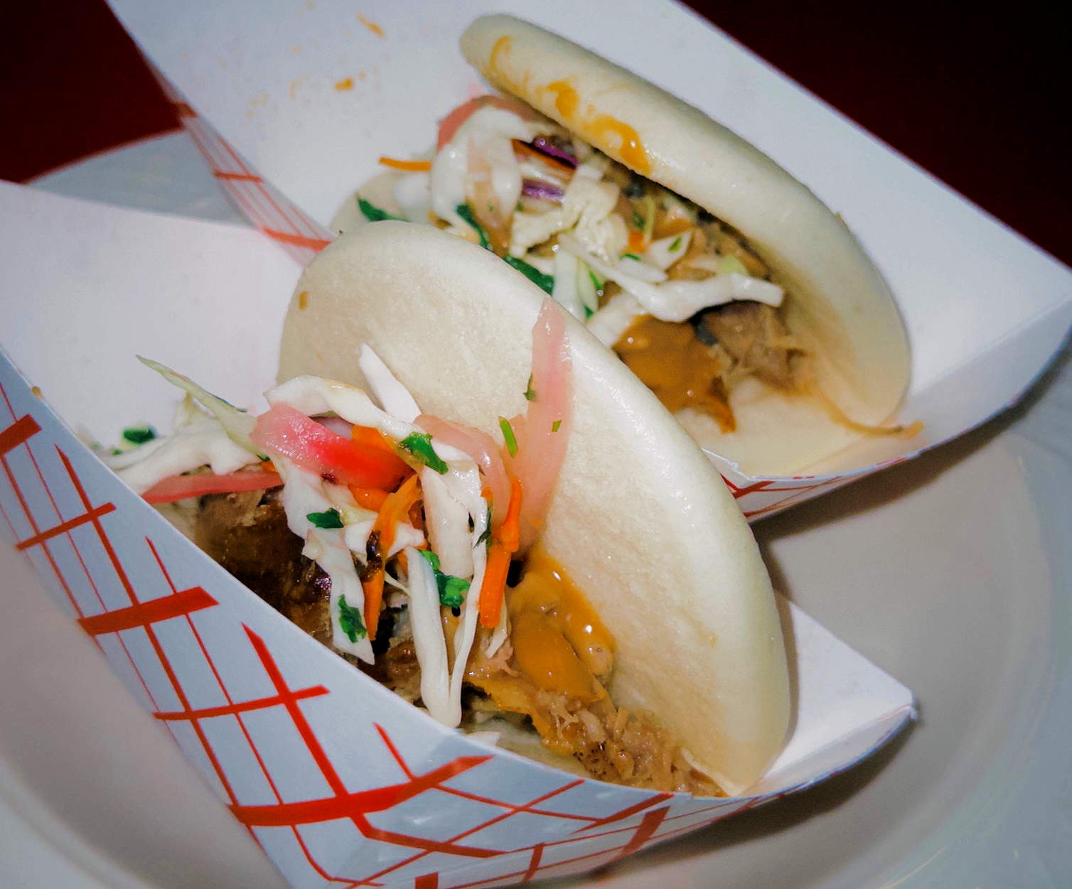 A closeup of bao buns in paper baskets