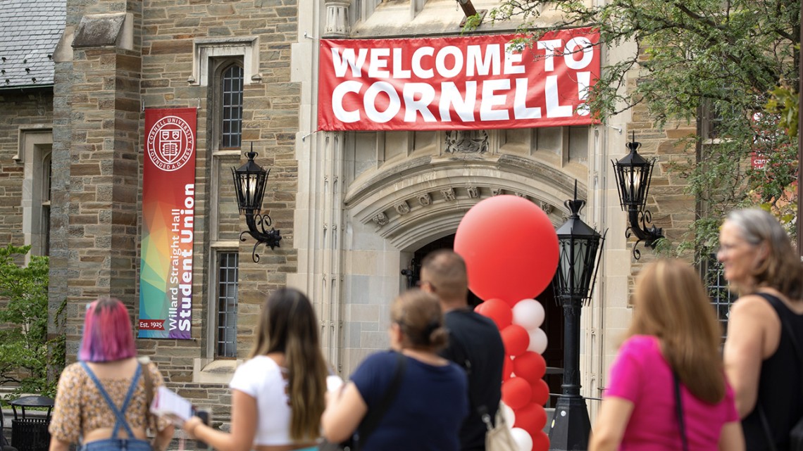 Photo of Willard Straight Hall with welcome signage for new students and families