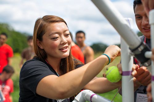 Participant setting up a trebuchet as part of a portable teambuilding program