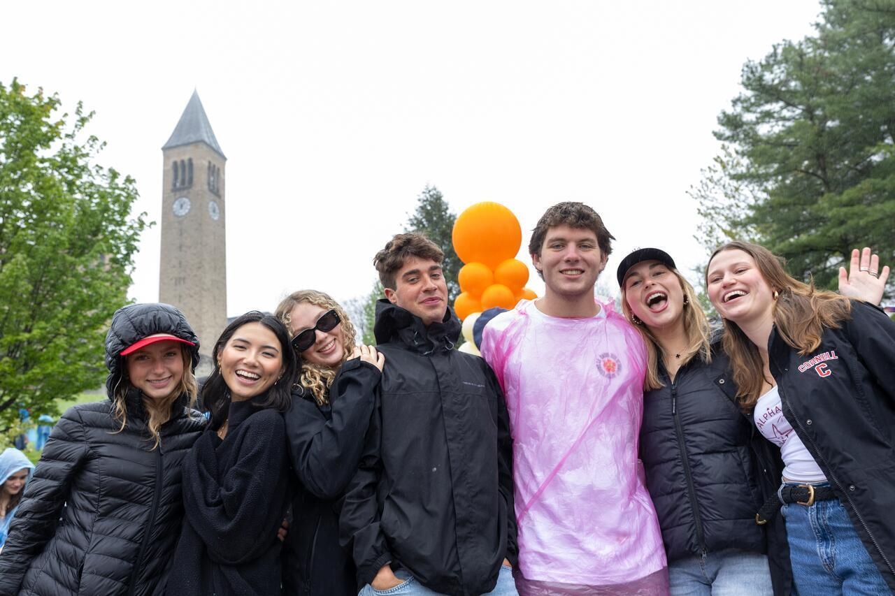 Students gather with friends on Ho Plaza, with McGraw Tower in the background.