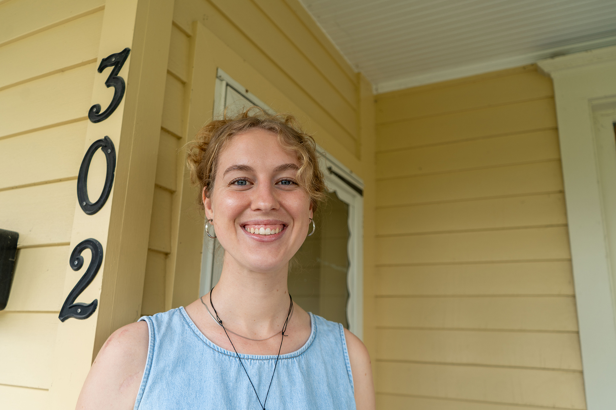 Julia Dahl '25 stands on the porch of Wait Ave