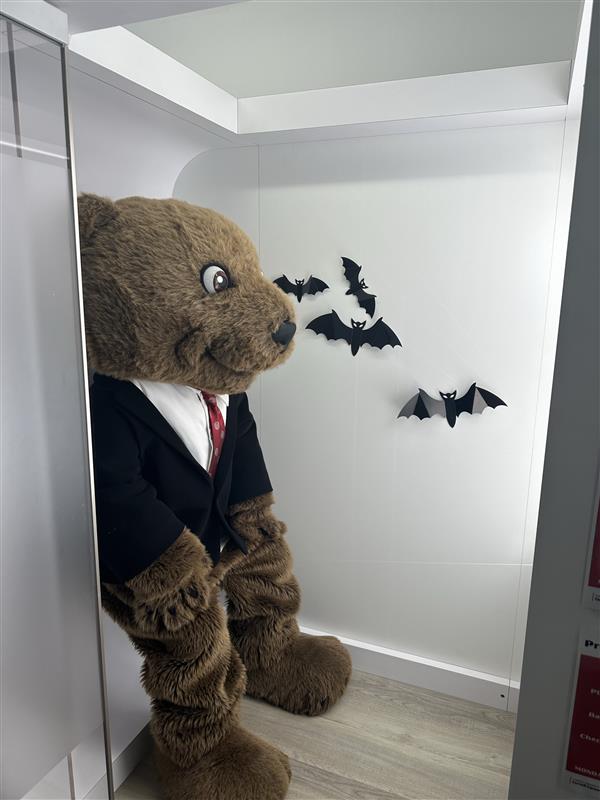 Cornell's mascot Touchdown dressed in a suit taking a photo in the Profile Picture Kiosk