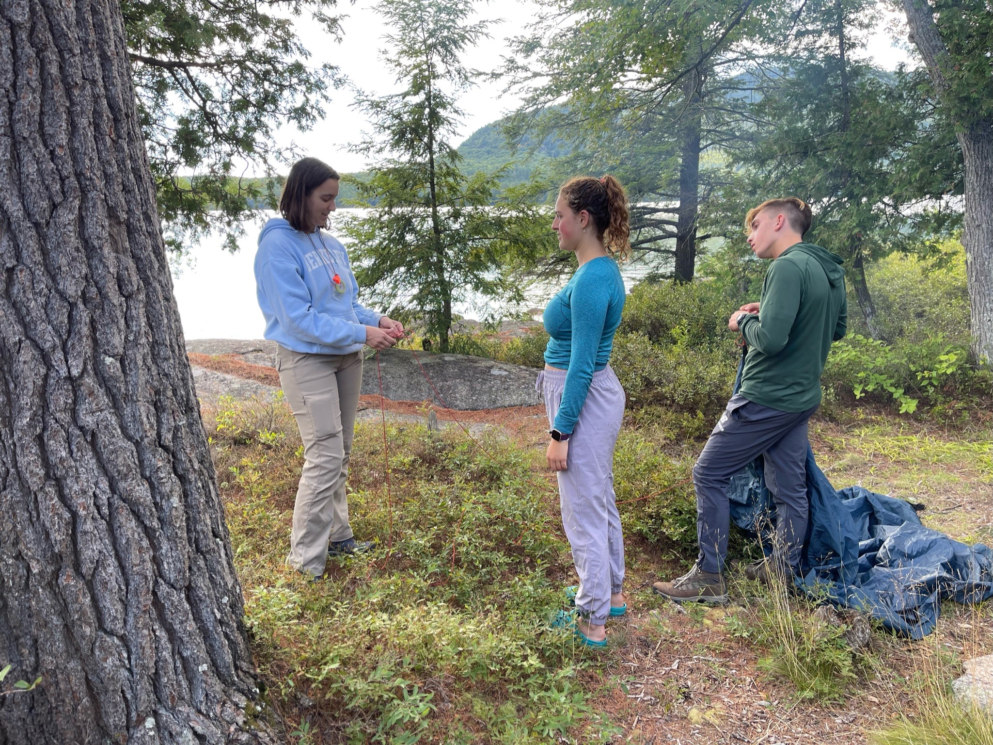 Bella with other students outside pitching a tent