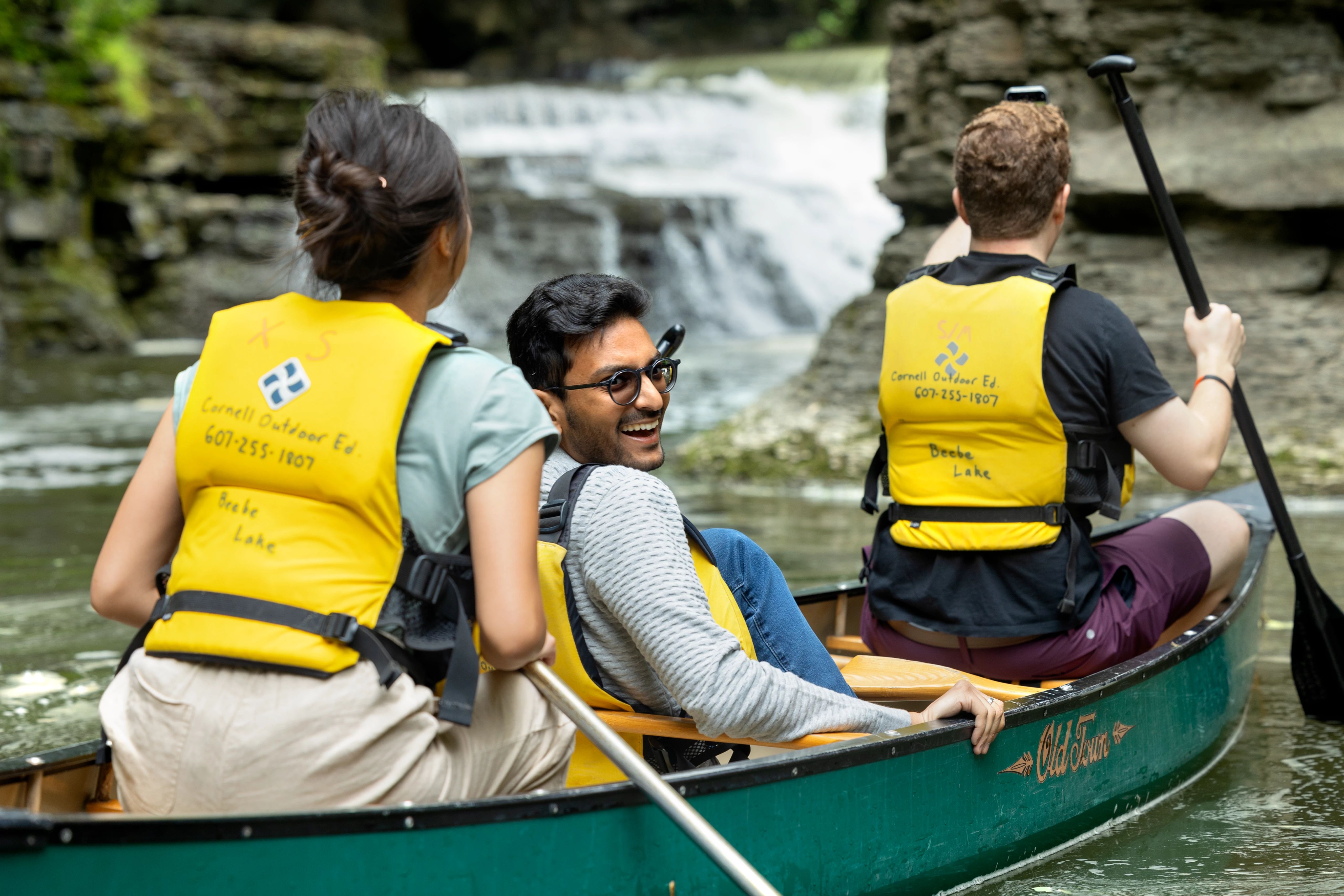 Three people in a canoe on Beebe Lake