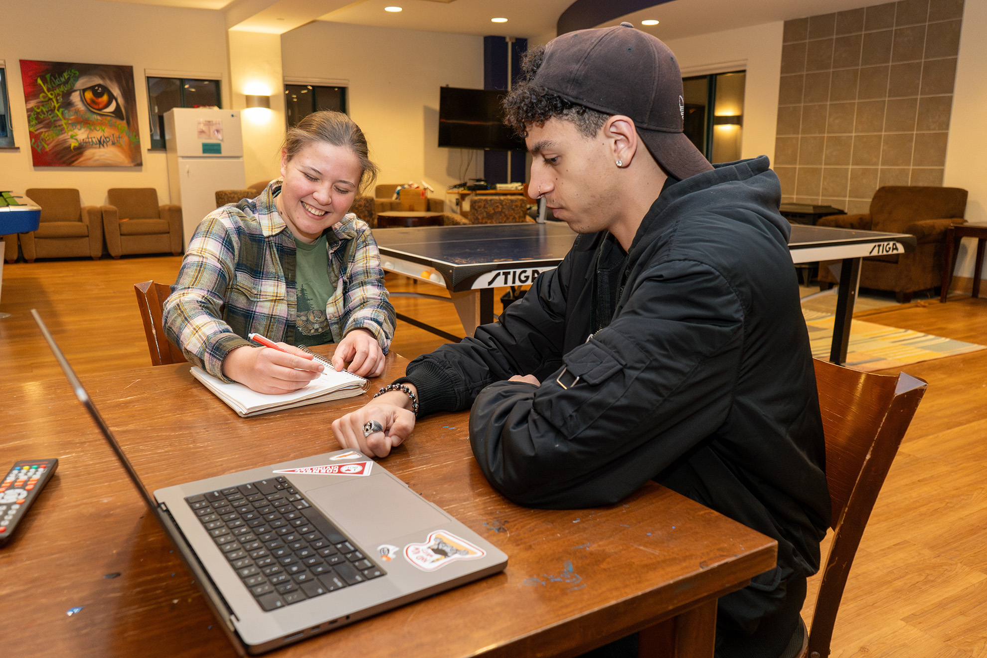 Residents in a lounge working on a project together