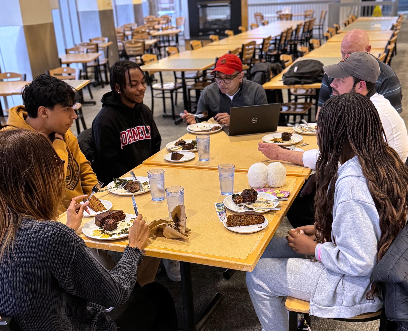 People sit around a table with plates of food