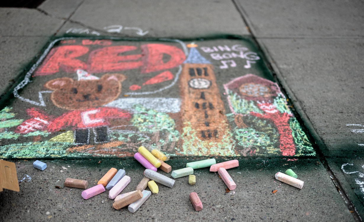 chalk drawing of Cornell Big Red Bear, the clock tower, and a tree on a sidewalk