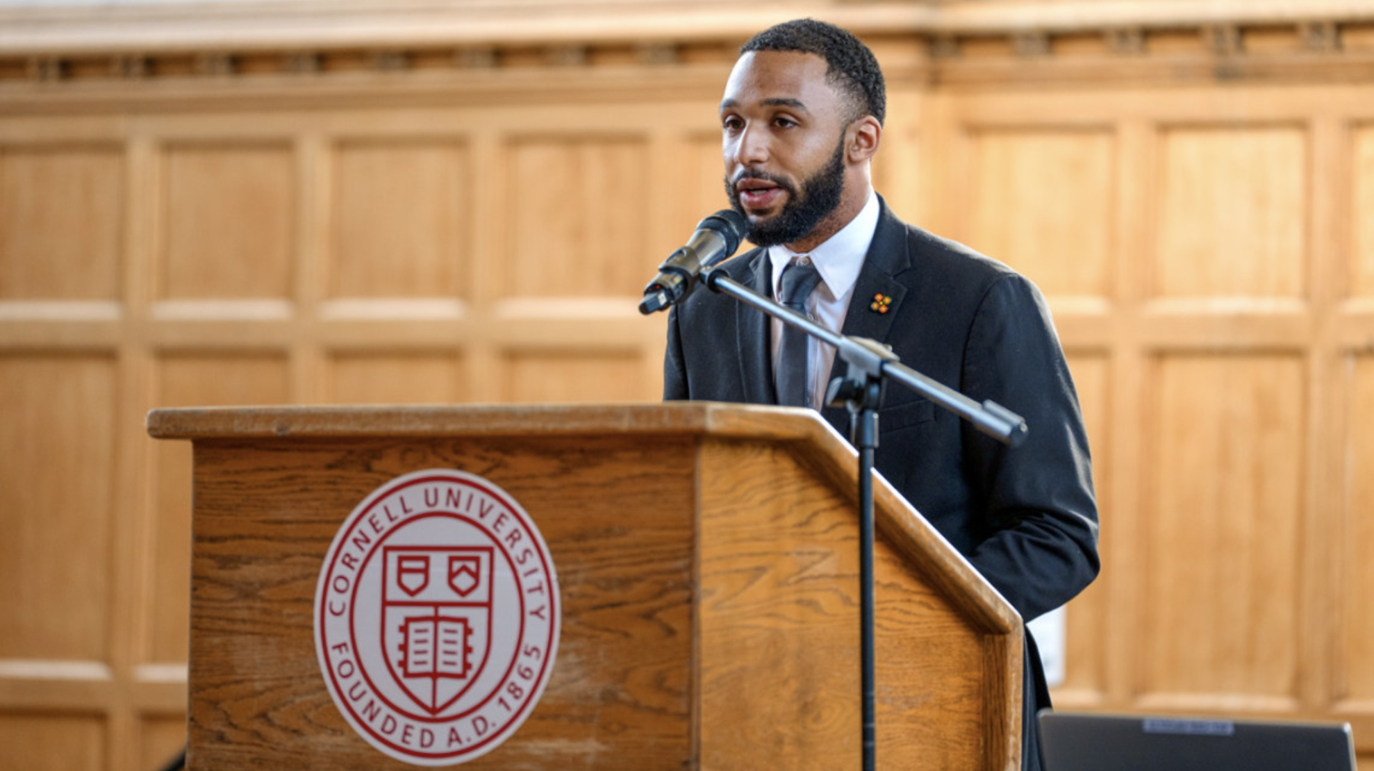 Student speaking at a podium in willard straight hall