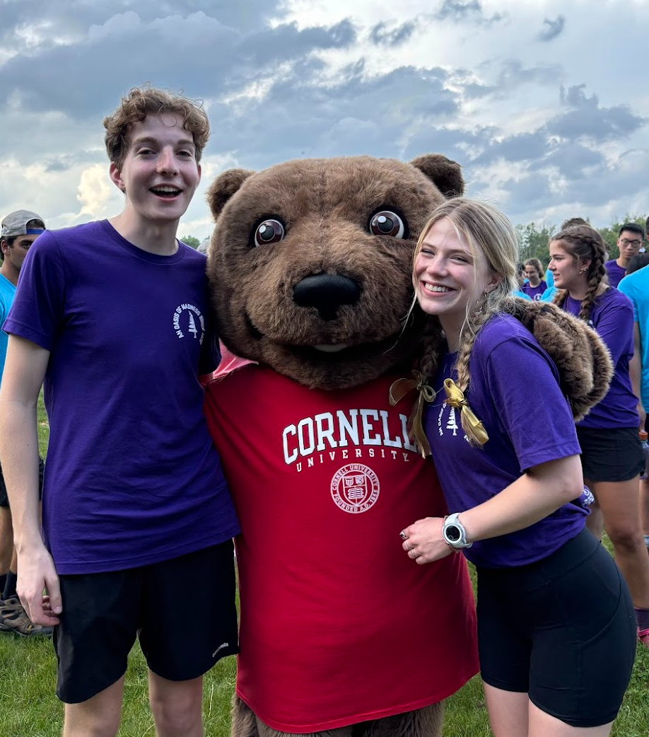 The 2024-2025 Outdoor Odyssey coordinators smile with Touchdown.