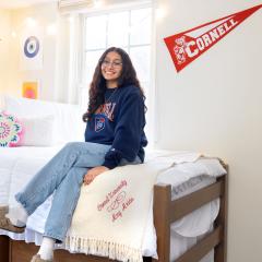 A resident of Latino Living Center sitting on their bed