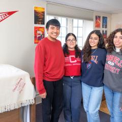 Residents of Latino Living Center posing in a bedroom
