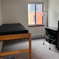 Bedroom in 301 College Avenue with bed, desk and dresser