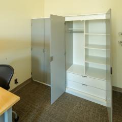 A dresser open to showcase the shelves and drawers.