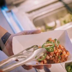 Guest serving themselves on a food line 