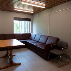 104 Mary Anne Wood Drive main lounge with couches, chairs, and a table.