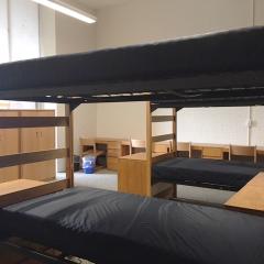 Room with four bunk beds and lots of light