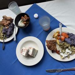 Plates of food on a blue tablecloth