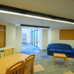 A lounge with couches, tables, and chairs.