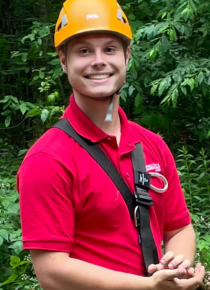 man in red shirt with orange helmet