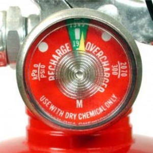Fire extinguisher gauge with the pin pointing within the green sector representing a charged extinguisher.