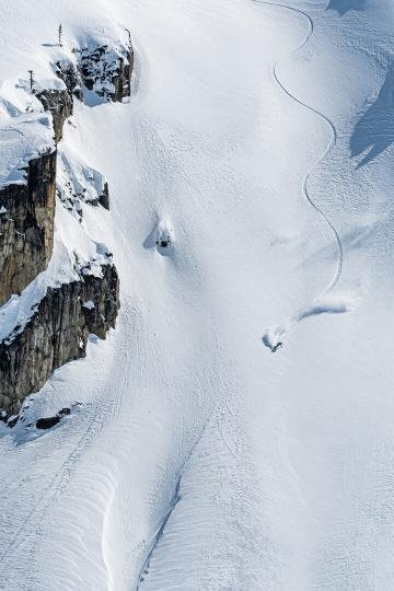 track down a snowy mountain with cliff on left