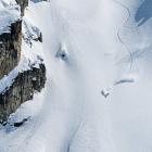 track down a snowy mountain with cliff on left