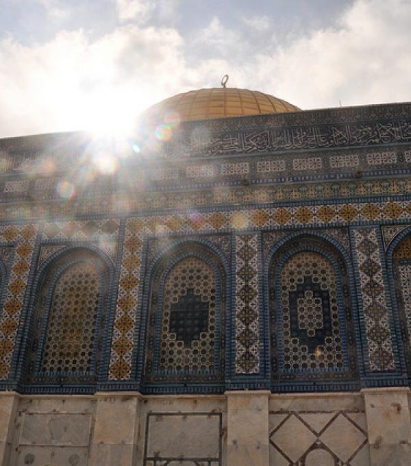 A Mosque with sunlight glinting over it