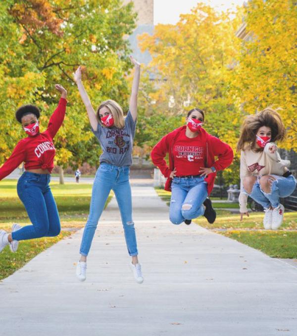 Members of Cornell Dance Team jumping on Arts Quad in fall
