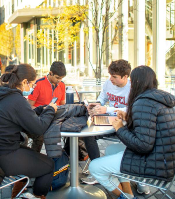 Students sit outside of Toni Morrison Hall studying