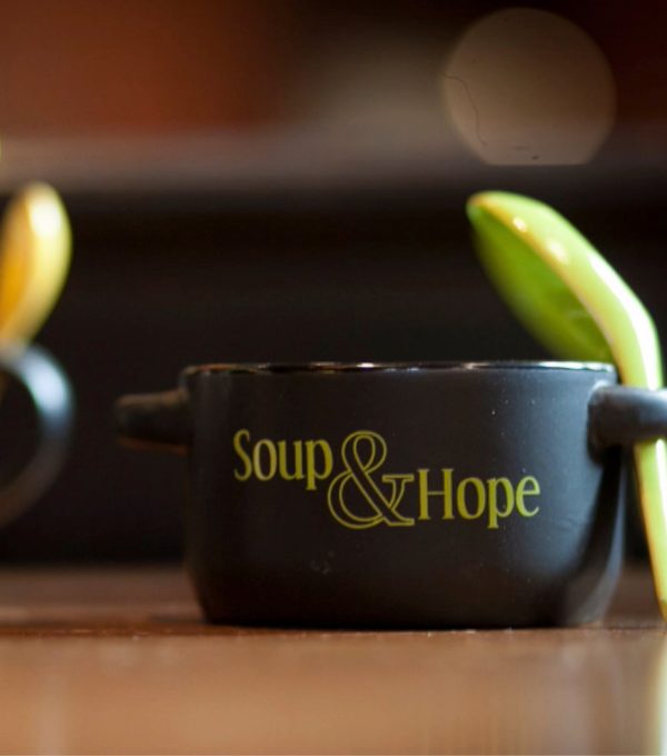 Black Soup and Hope bowl with green spoon