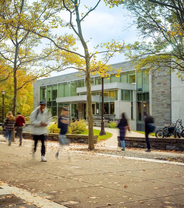 Photo of Ho Plaza with students walking in front of Cornell Health