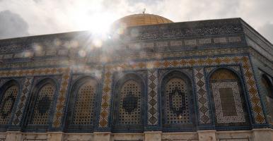 A Mosque with sunlight glinting over it
