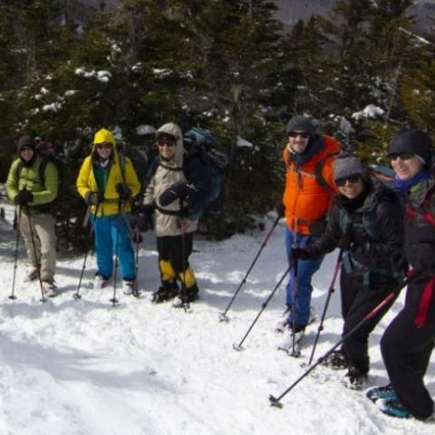 people hiking a snowy mountain in New York