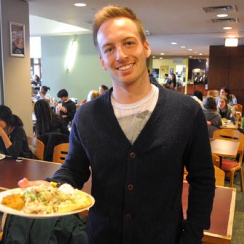 Student holding a plate of food