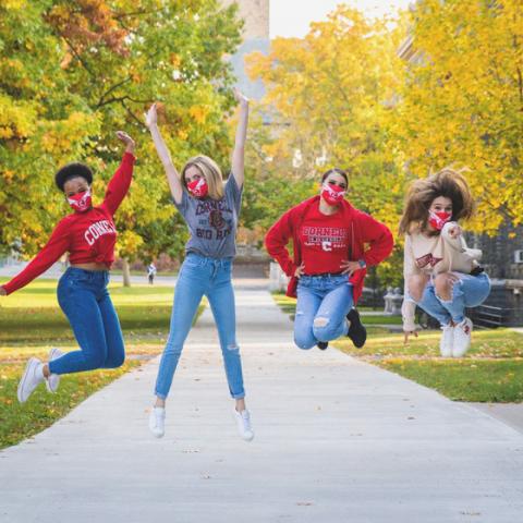 Members of Cornell Dance Team jumping on Arts Quad in fall