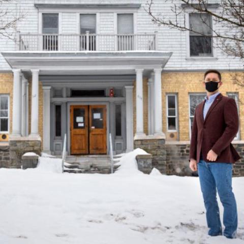 Mark Minton ’23, CUVA’s current vice president, stands in front of 625 University Ave., a university-managed property that will become a program house for undergraduate student veterans this fall