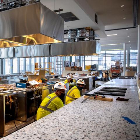 Construction team assembles counter tops in new Discovery Kitchen 