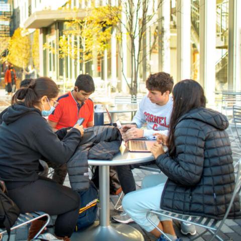 Students sit outside of Toni Morrison Hall studying