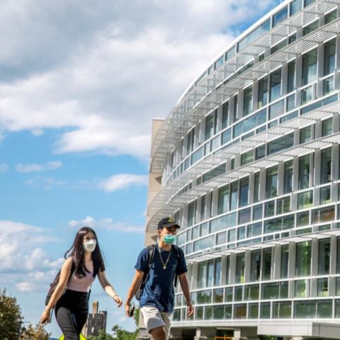 Students walk outside of Cornell Health building
