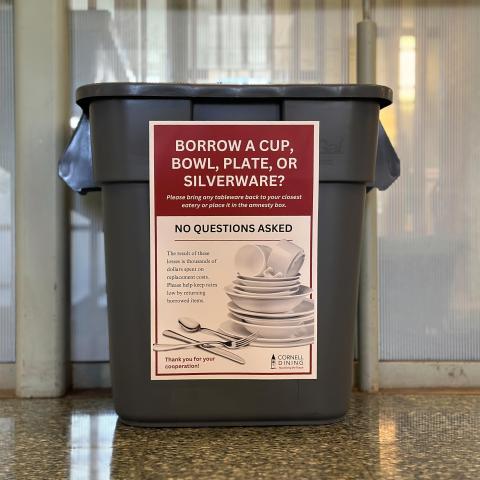 A bin sitting against a glass wall that says borrow a cup, bowl, plate, or silverware? Please bring any tableware back, no questions asked